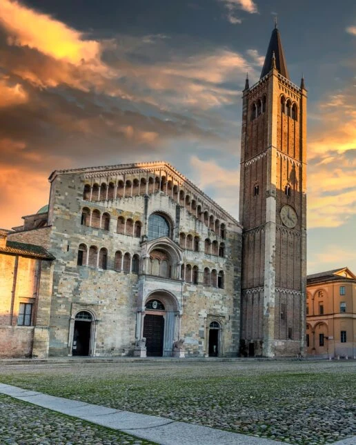 Parma Cathedral and its bell tower at sunset, central Piazza Duomo
